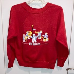 Women’s red sweatshirt with New Orleans  bear band. Designpoint.